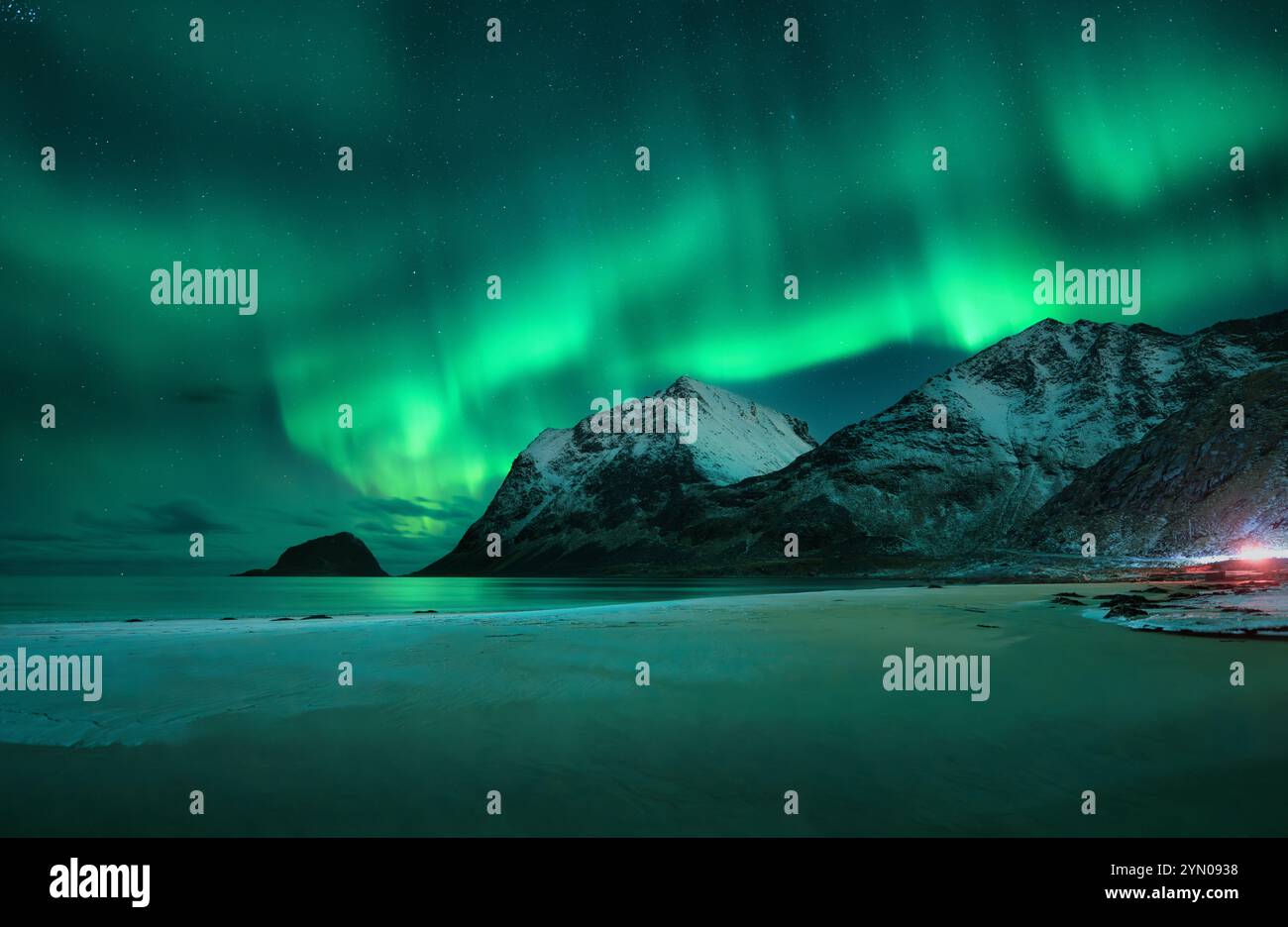 Aurora borealis on night sky over snowy mountains and sandy beach Stock ...
