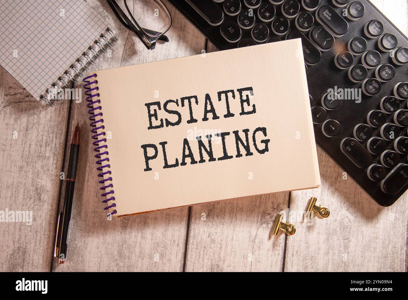 Tax form with business card with text Estate Planing. Notepad, eyeglasses and white pen. Financial concept Stock Photo