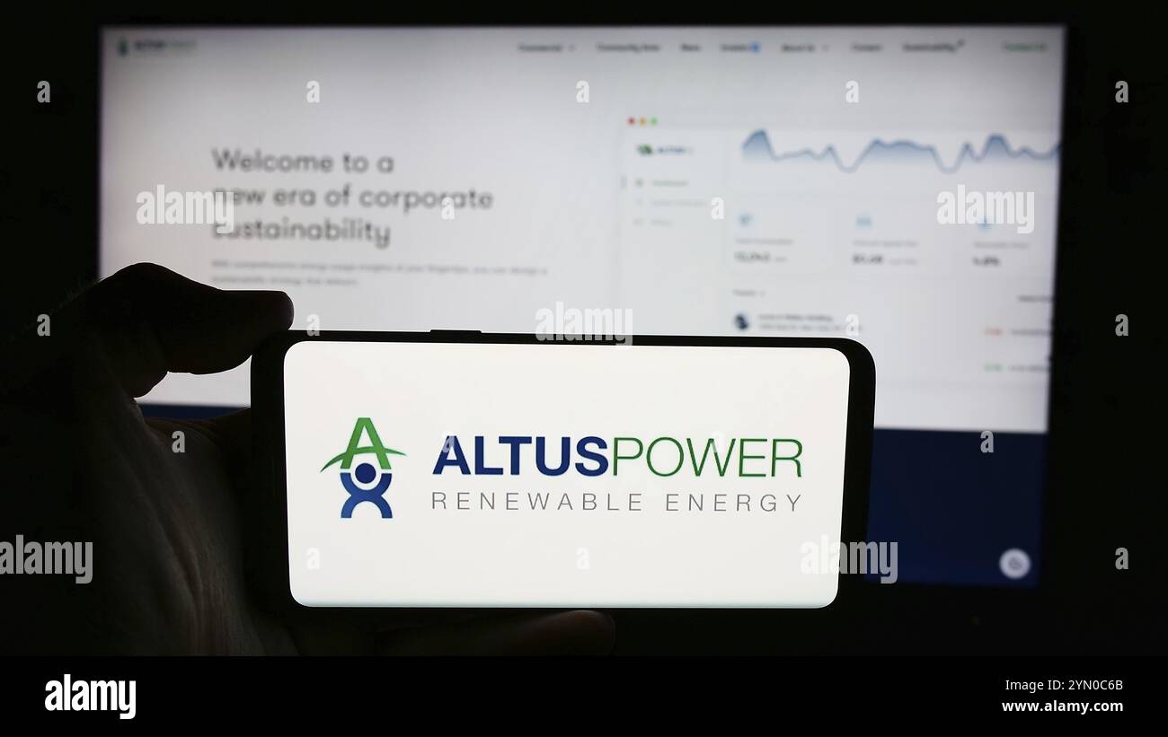Stuttgart, Germany, 07-03-2024: Person holding cellphone with logo of US solar energy company Altus Power Inc. in front of business webpage. Focus on Stock Photo