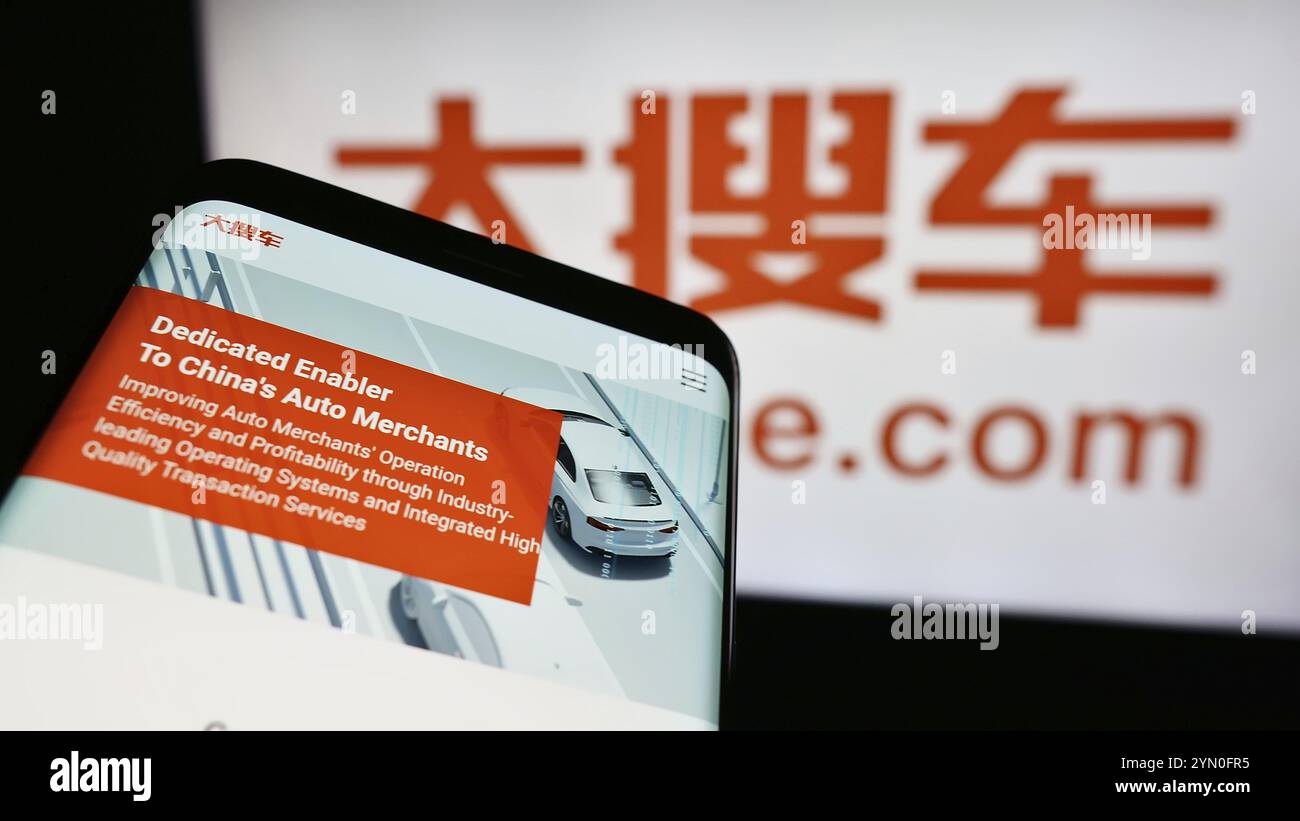 Stuttgart, Germany, 06-11-2024: Mobile phone with webpage of Chinese car marketplace company Souche Holdings Ltd. in front of business logo. Focus on Stock Photo