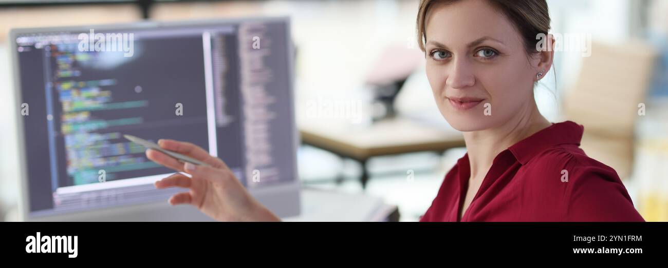 Woman shows with pen on complex code developing software Stock Photo