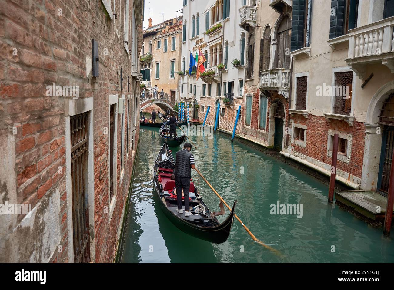 Venice,Italy;October,17,2024:a narrow canal in Venice, Italy, where elegant gondolas glide effortlessly through calm waters. Stock Photo