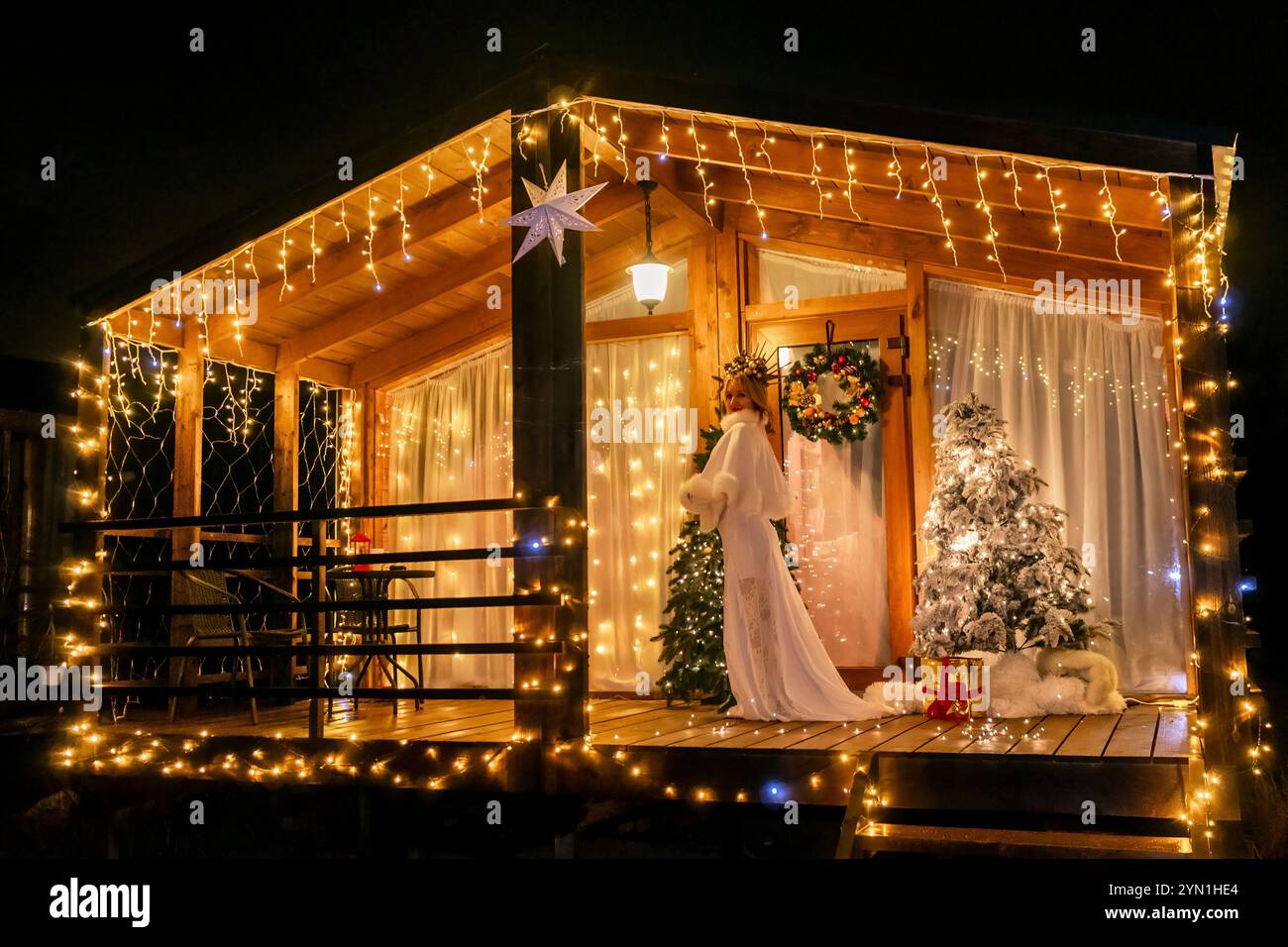 Christmas Lights Cabin Decor Night A wooden cabin decorated for ...