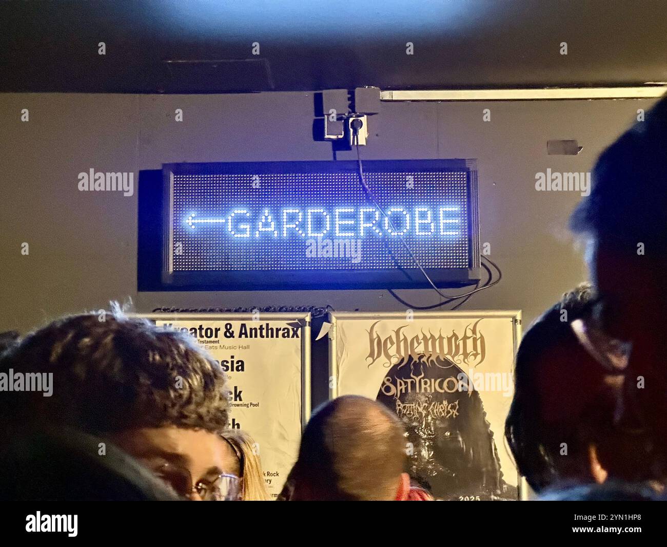 Sign pointing the way to the cloakroom (Garderobe) in the German club and concert venue Columbiahalle, Berlin, Germany - Smartphone Captured Stock Image