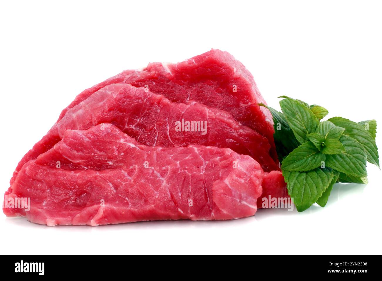 Cut of  beef steak with green leaf. Isolated. Stock Photo