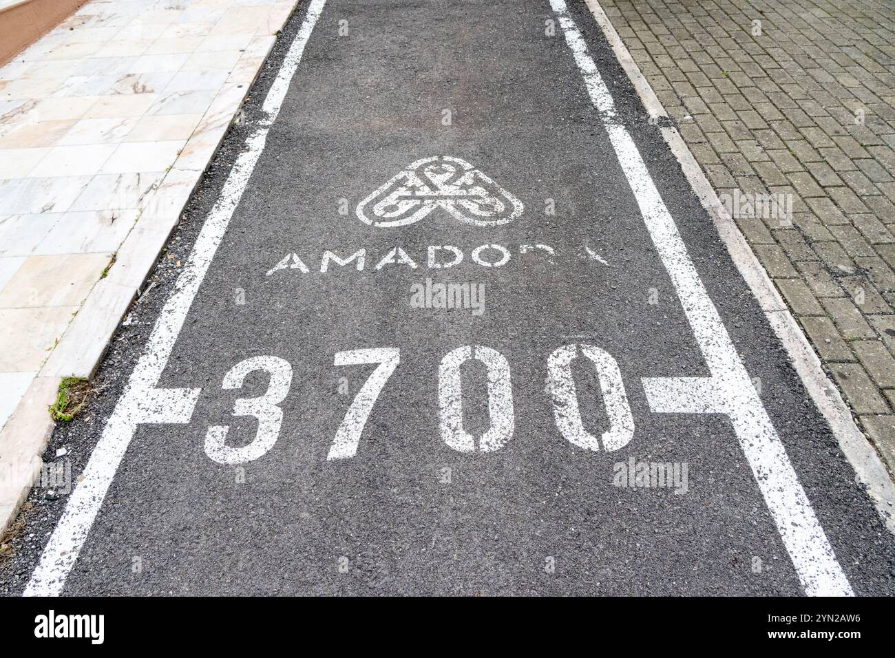 Bike path signage indicating the city of amadora and its postal code ...