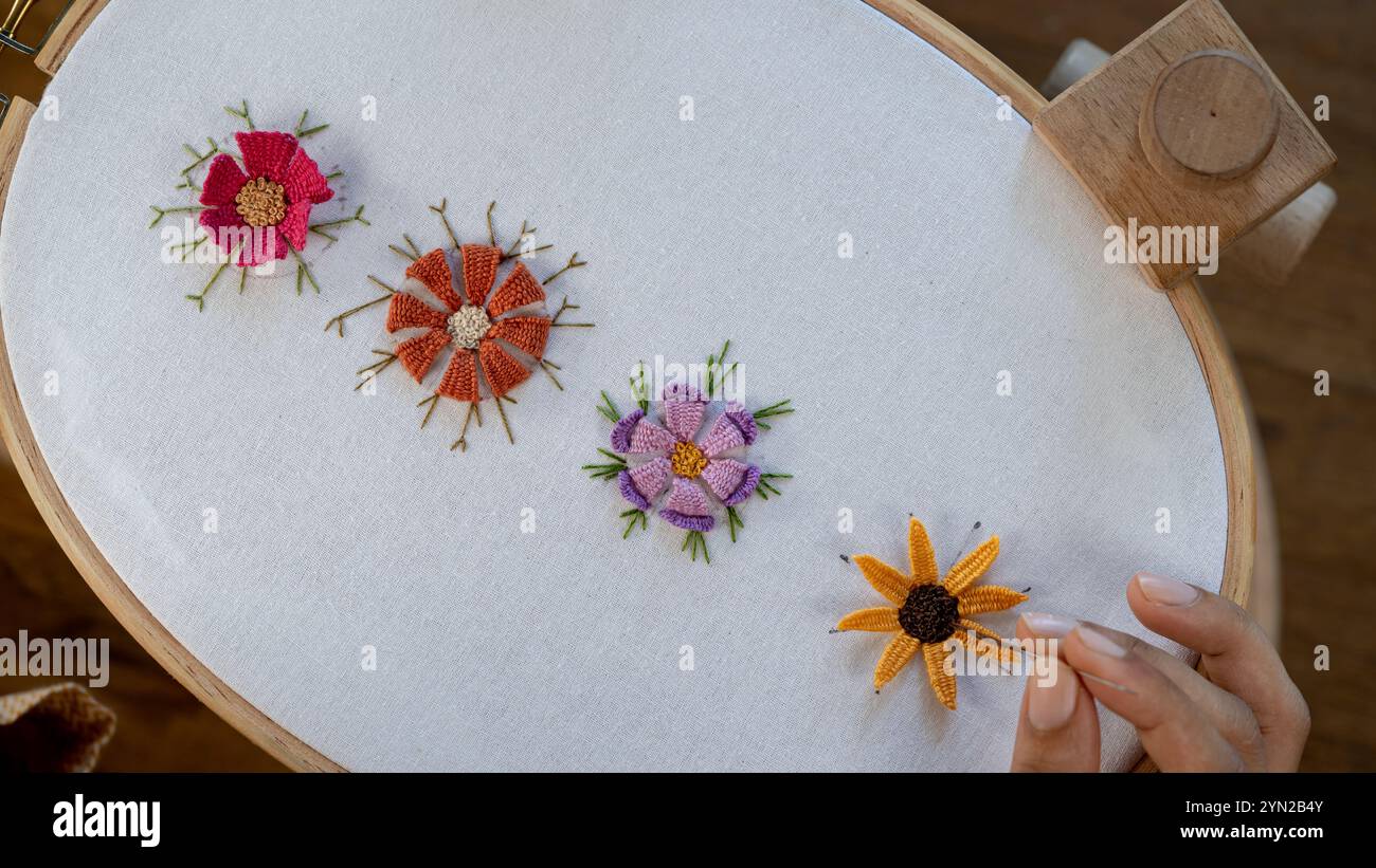 Needle and Thread Magic: Creating Flowers with Colorful Threads Stock ...