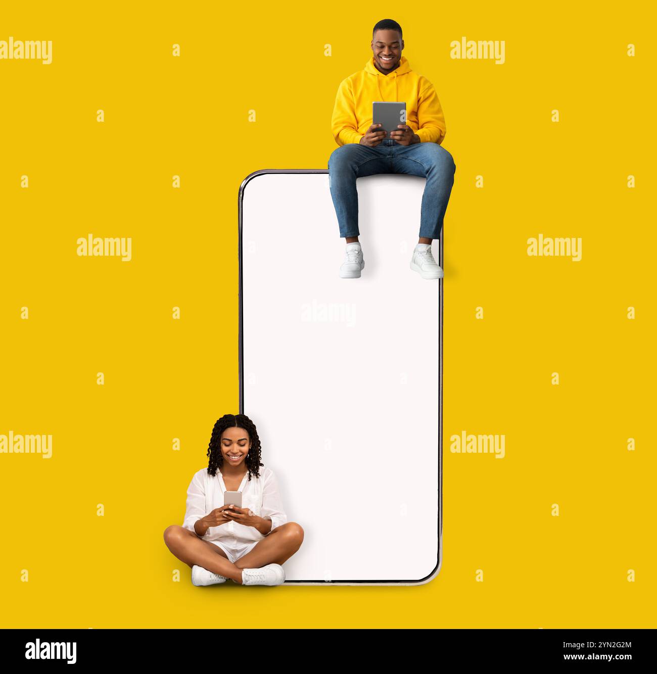 Couple sitting on white empty smartphone screen and using phones Stock Photo