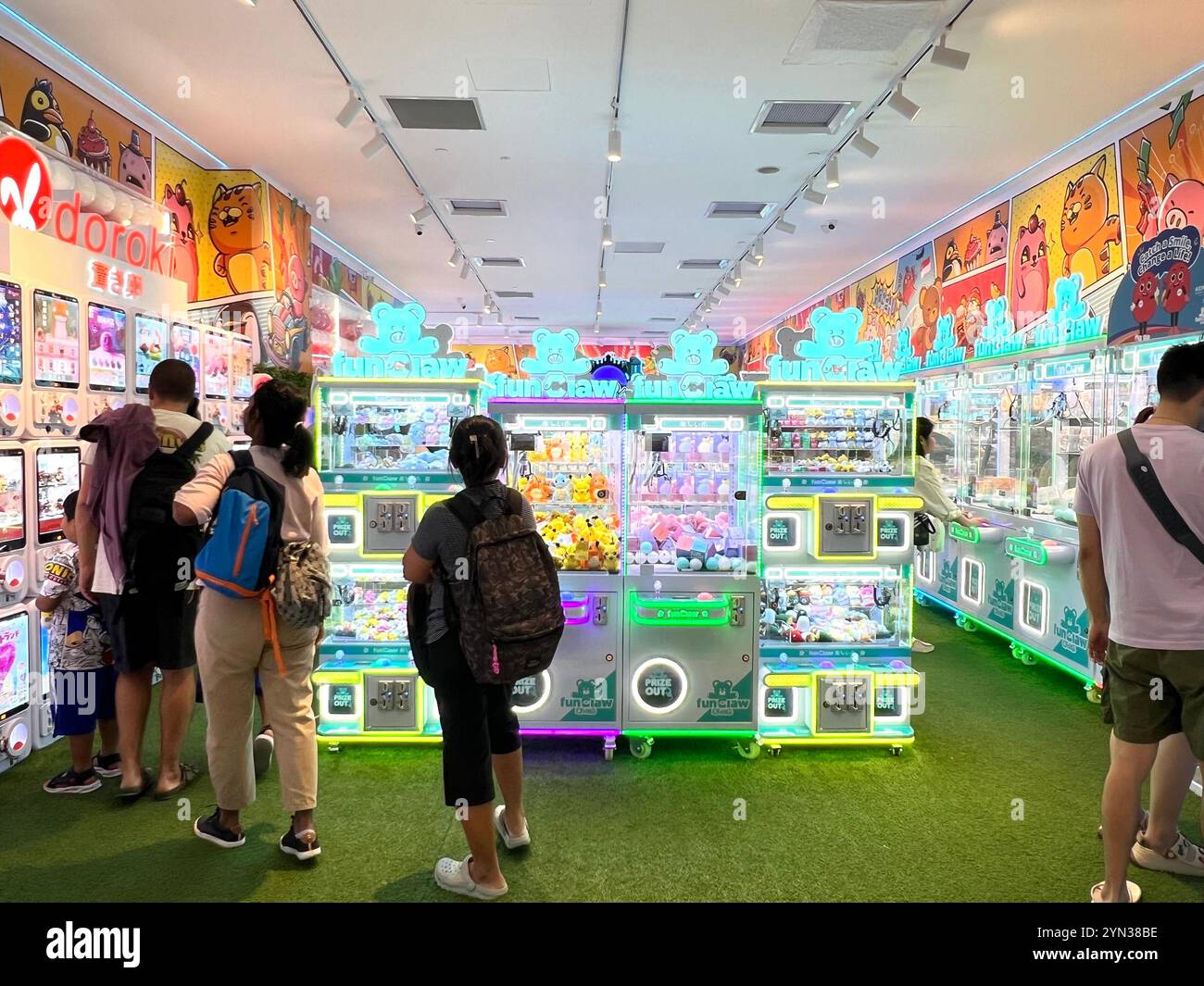 Bright claw machines shop attract customers to play crane game activity, a trendy addiction for some people. Singapore. - Smartphone Captured Stock Image