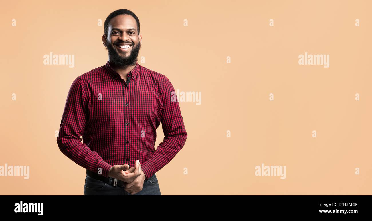 Smiling afro man posing on orange background Stock Photo