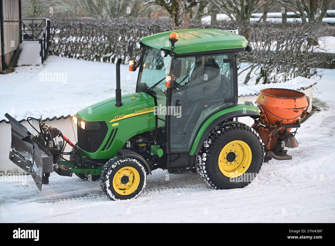 Skånes-Fagerhult, Skåne, Sweden. November 23 2024. Snow plowing tractor in the street. Stock Photo