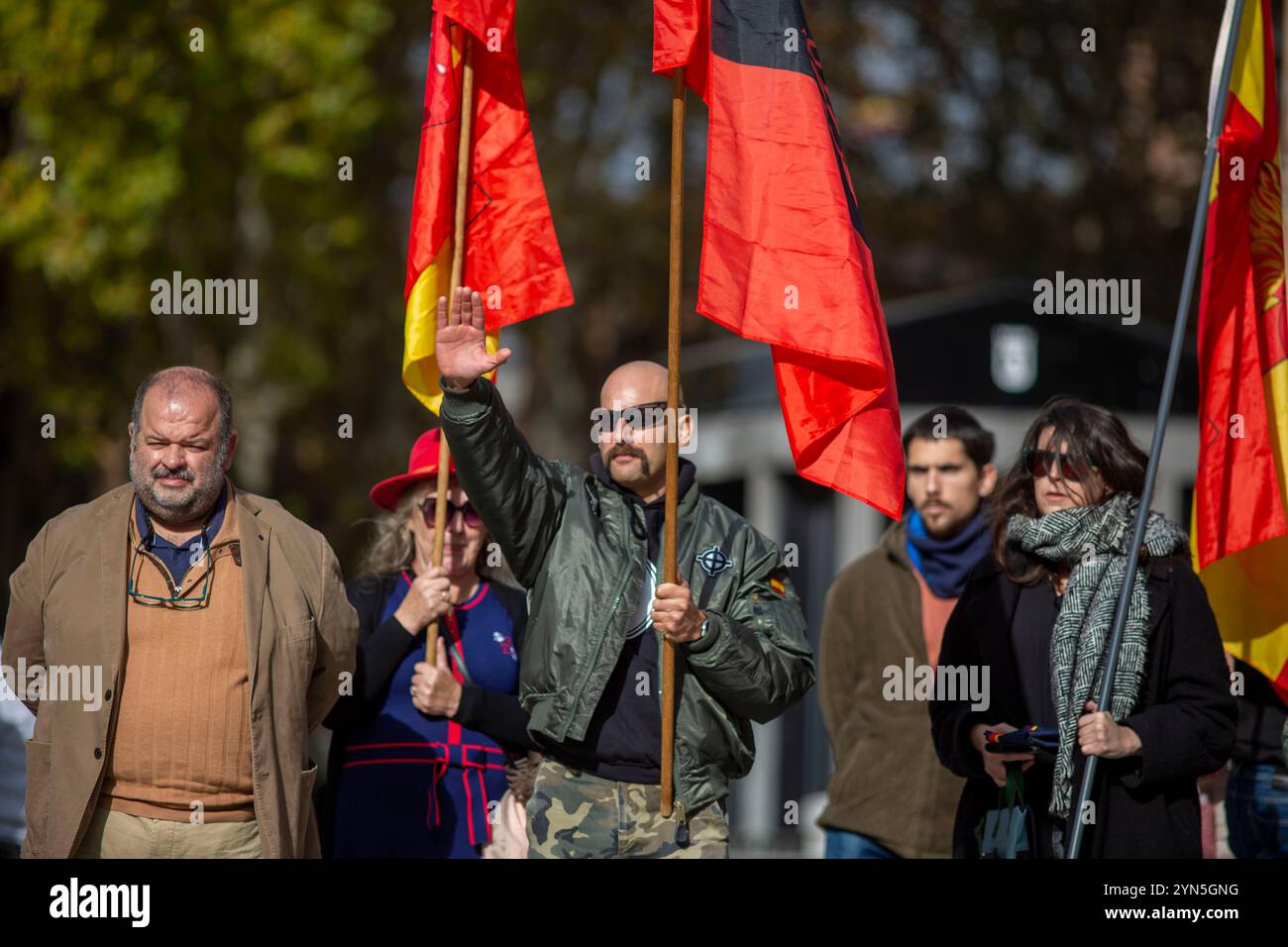 Madrid, Spain. 24th Nov, 2024. Supporters hold Francoist and Falangist flags, during a rally commemorating the anniversary of the death of dictator Francisco Franco on November 20, 1975 and of José Antonio Primo de Rivera on November 20, 1936, founder of the right-wing group Falange Española, in the Plaza de Oriente, in Madrid. Credit: SOPA Images Limited/Alamy Live News Stock Photo