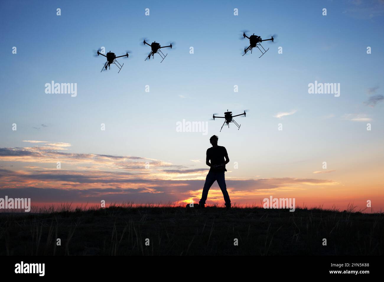 Man controlling a swarm of drones (UAVs) Stock Photo