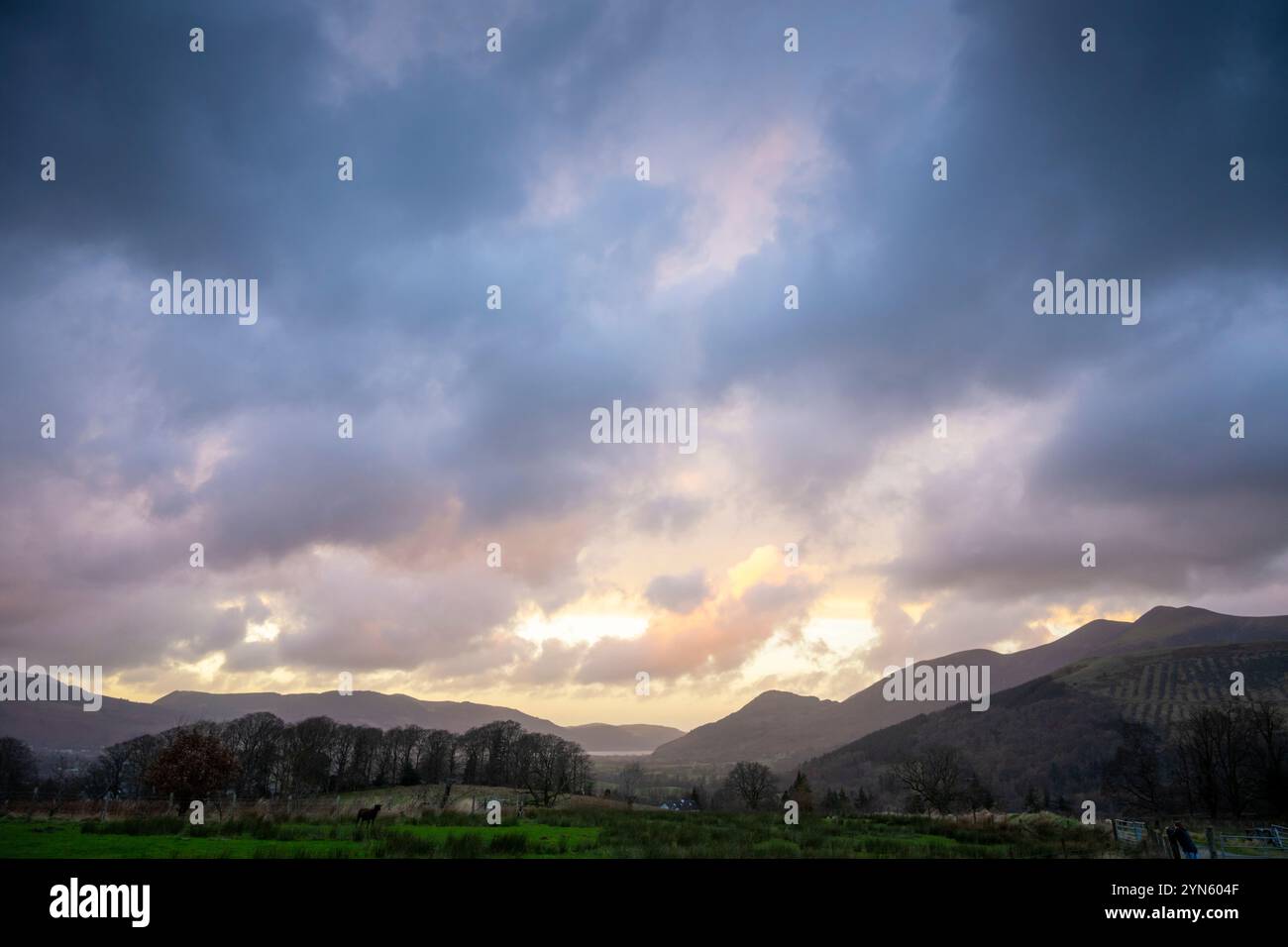 Keswick, Cumbria, 24th November 2024. Dramatic clouds scud over the Cumbrian fells at dusk near Keswick as the remains of Storm Bert pass over the Lake District. The weather consisted of high winds and showers as the sun sets. Credit: Julian Eales/Alamy Live News Stock Photo