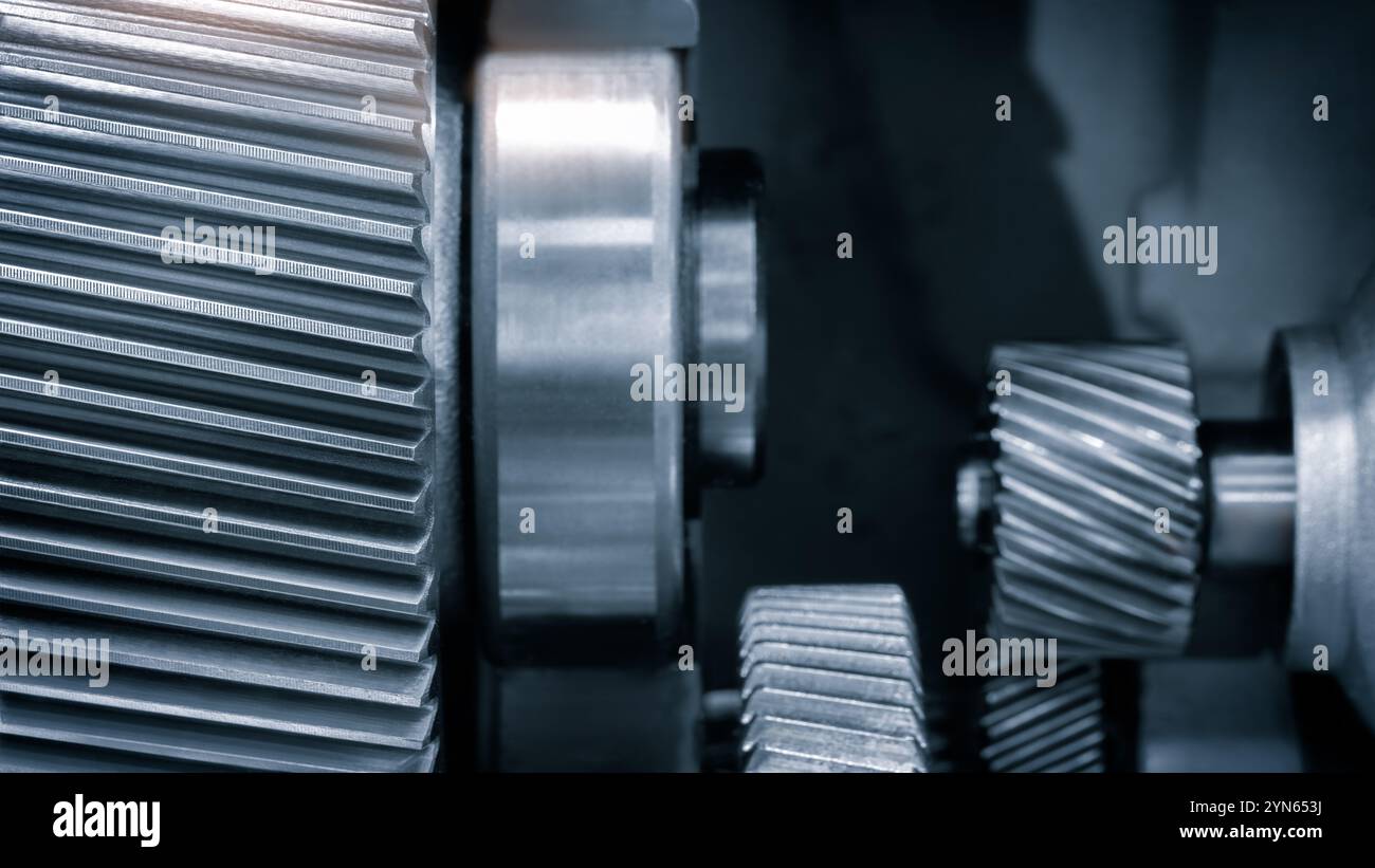 A close up of a gear with many teeth. The gear is part of a machine and ...