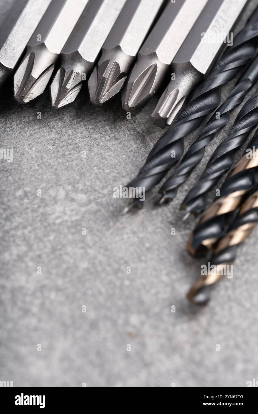 Set of drill bits on grey background. Close up. Selective focus Stock Photo