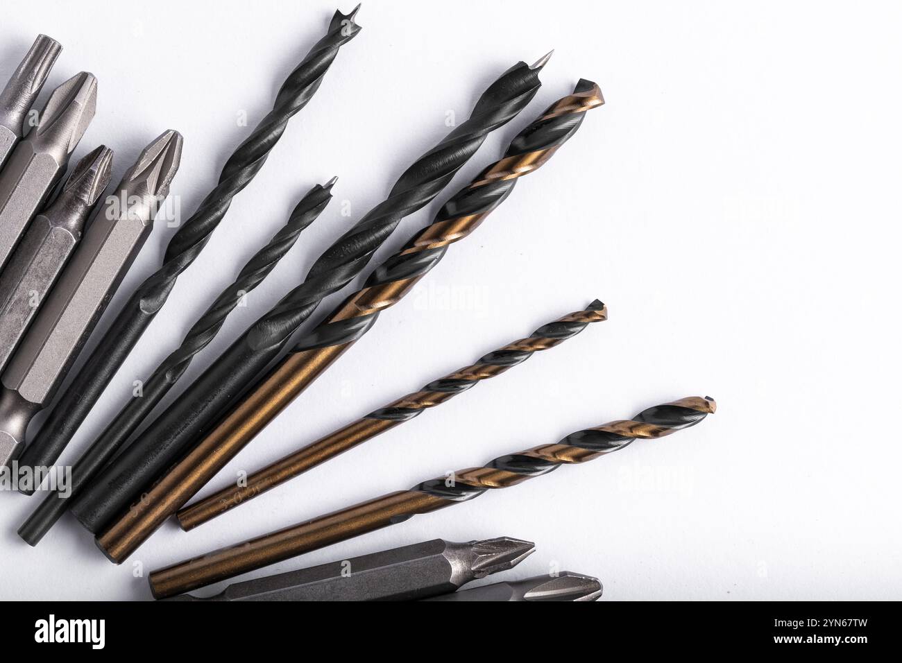 Set of various drill bits on white background. Top view Stock Photo