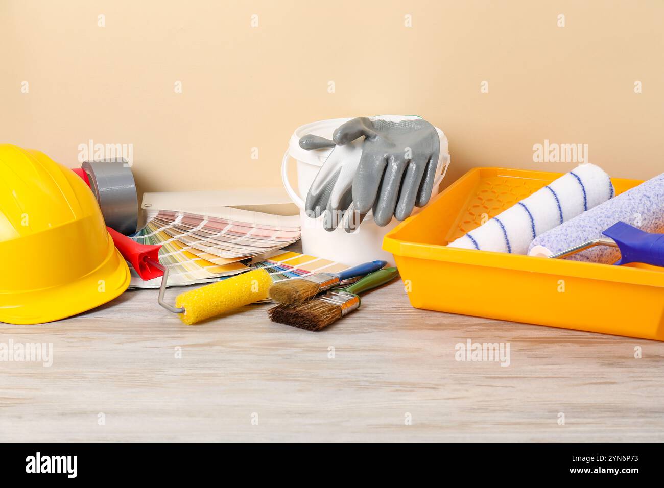 Different painter's tools on light wooden table. Decorating and design Stock Photo