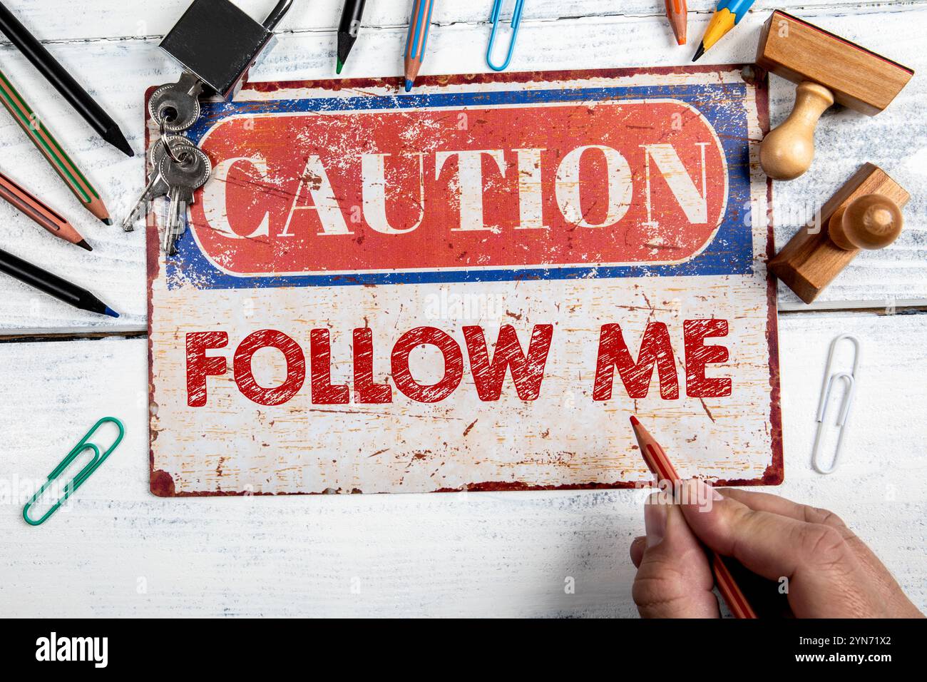 Follow Me. Warning sign on wooden office desk Stock Photo - Alamy