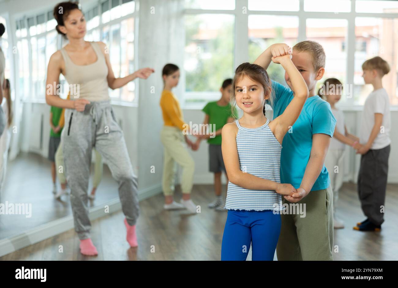 Girl paired up with boy and training to perform slow couple dance ...