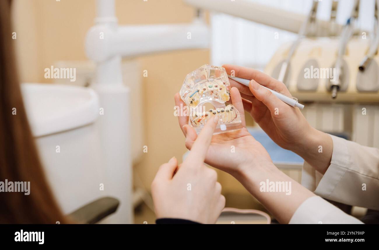 Orthodontic consultation with a dental model showing braces placement ...