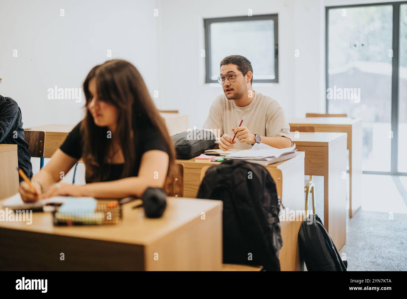 Focused high school students participating in classroom activities Stock Photo