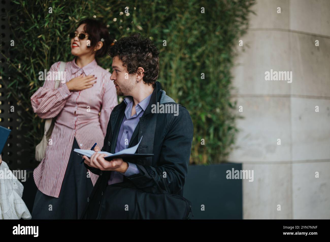 Two business professionals having outdoor discussion with notes Stock Photo