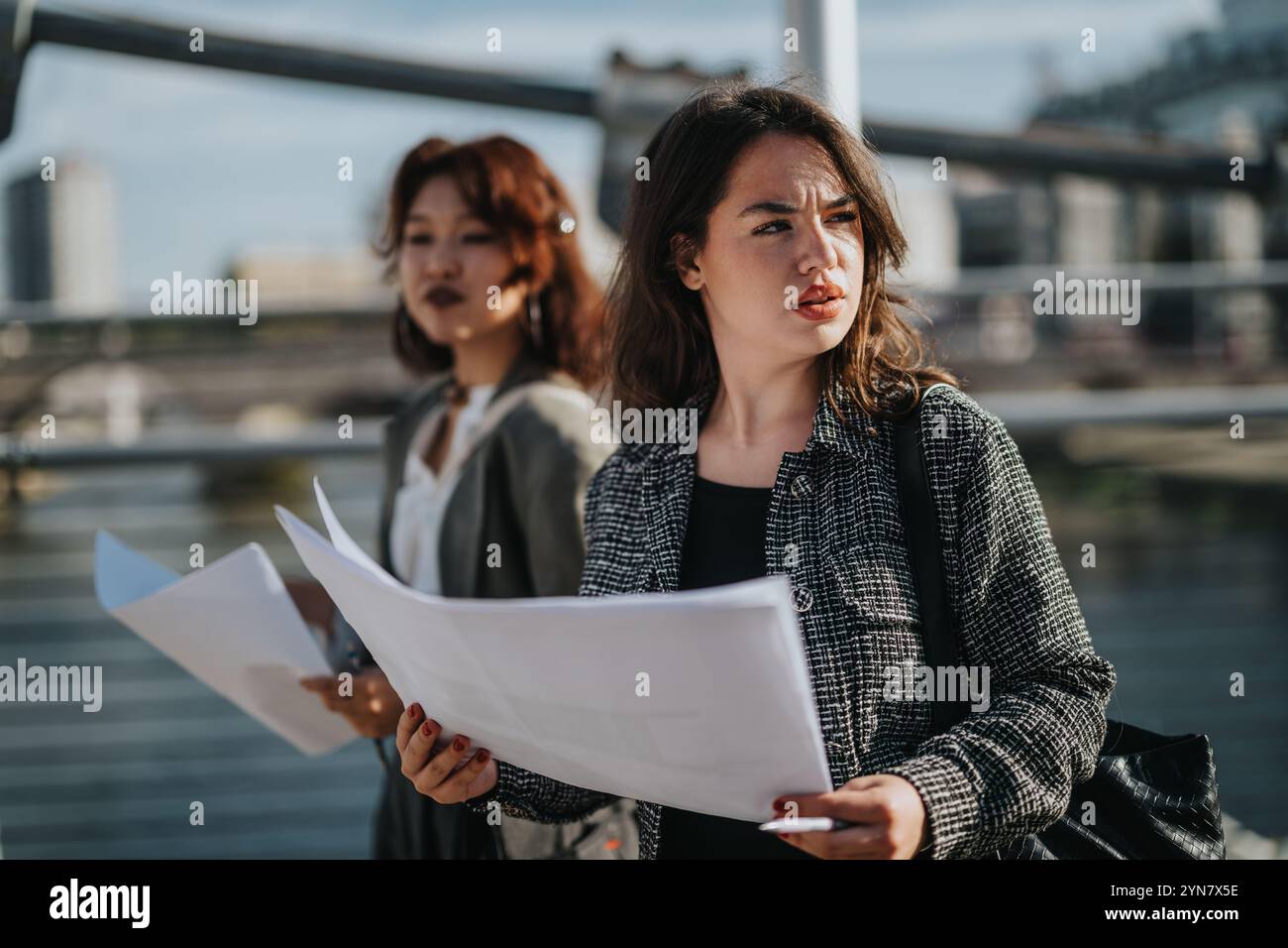 Multicultural business team analyzing documents outdoors Stock Photo