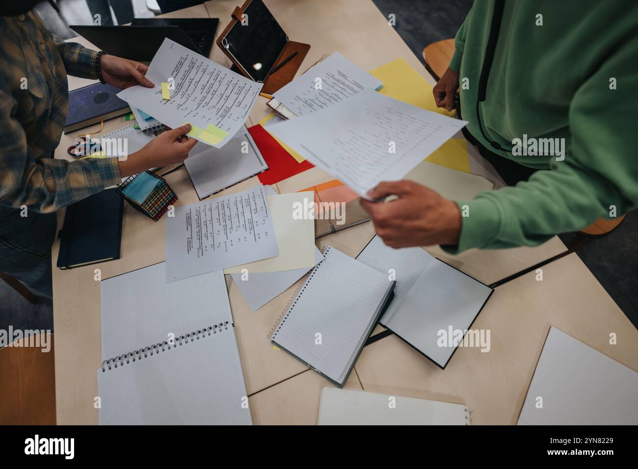 Students collaborating on assignments in a classroom setting Stock Photo