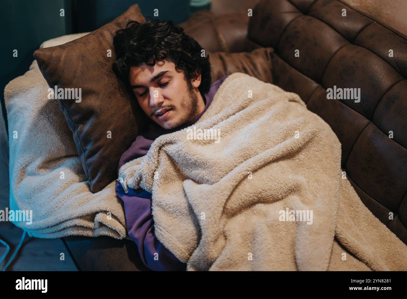 Young man sleeping in sofa hi-res stock photography and images - Alamy