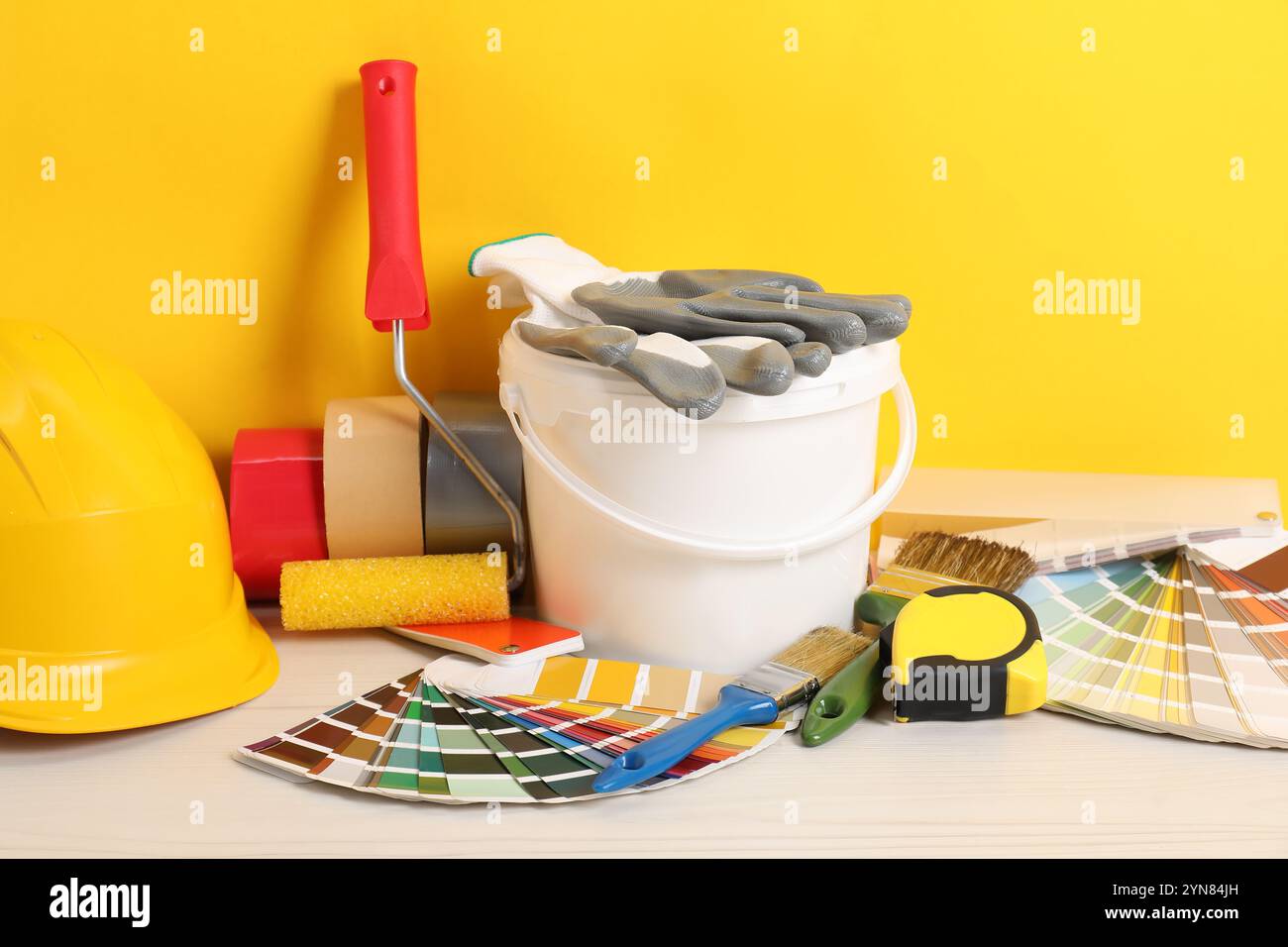 Different painter's tools on white wooden table. Decorating and design Stock Photo