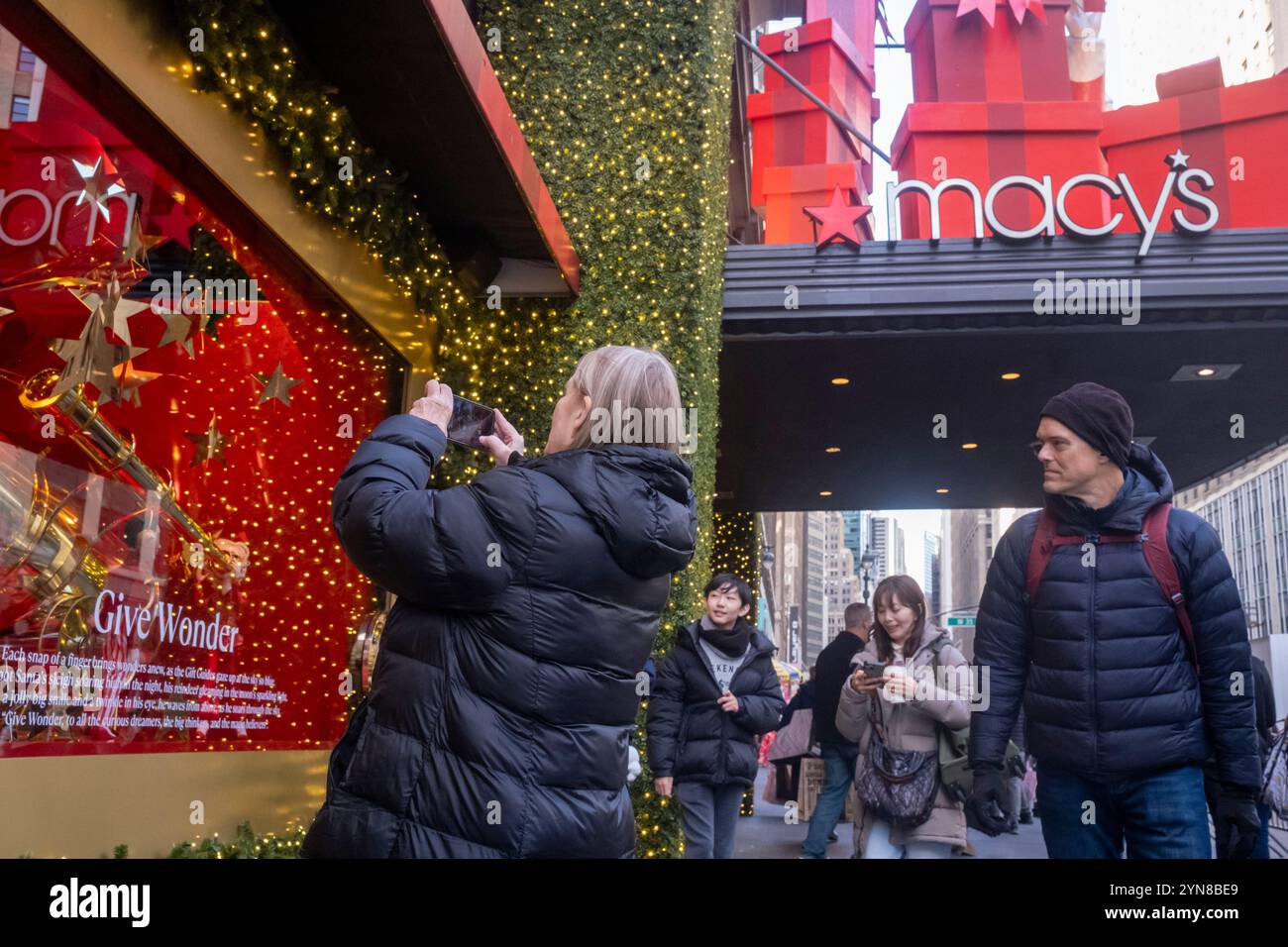 New York, United States. 24th Nov, 2024. People photograph the display ...