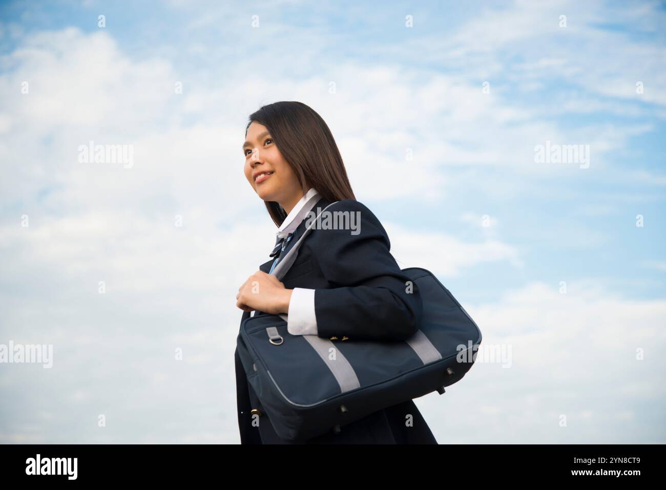 High school girl in school uniform laughing Stock Photo - Alamy