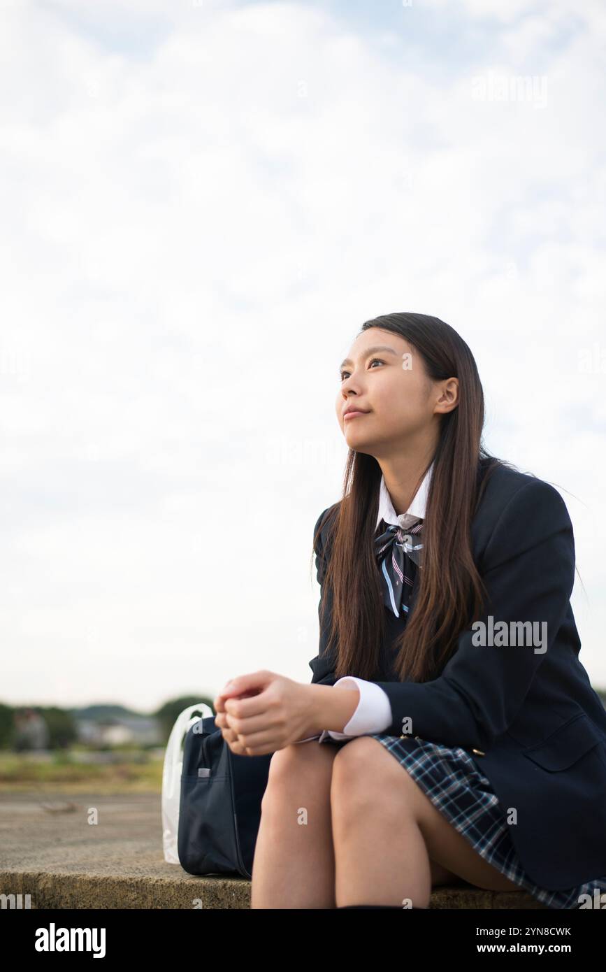 Sitting schoolgirl in uniform Stock Photo - Alamy