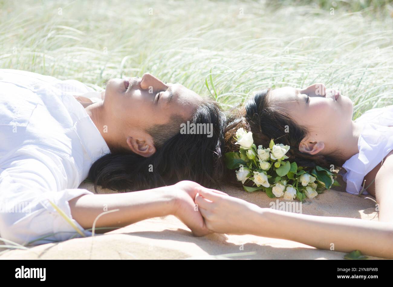 Couple lying on grass Stock Photo
