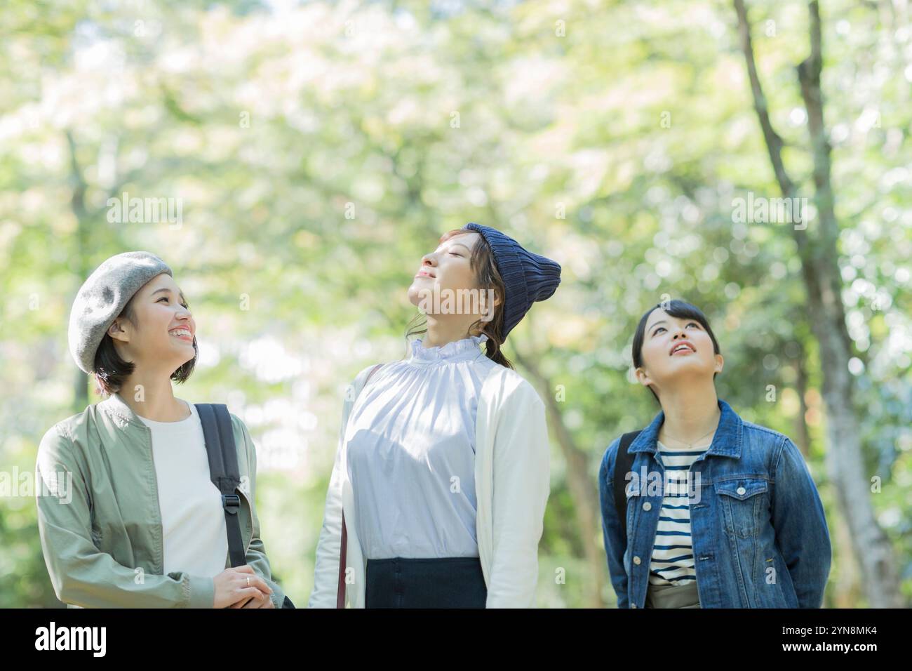 Three women smile up hi-res stock photography and images - Alamy
