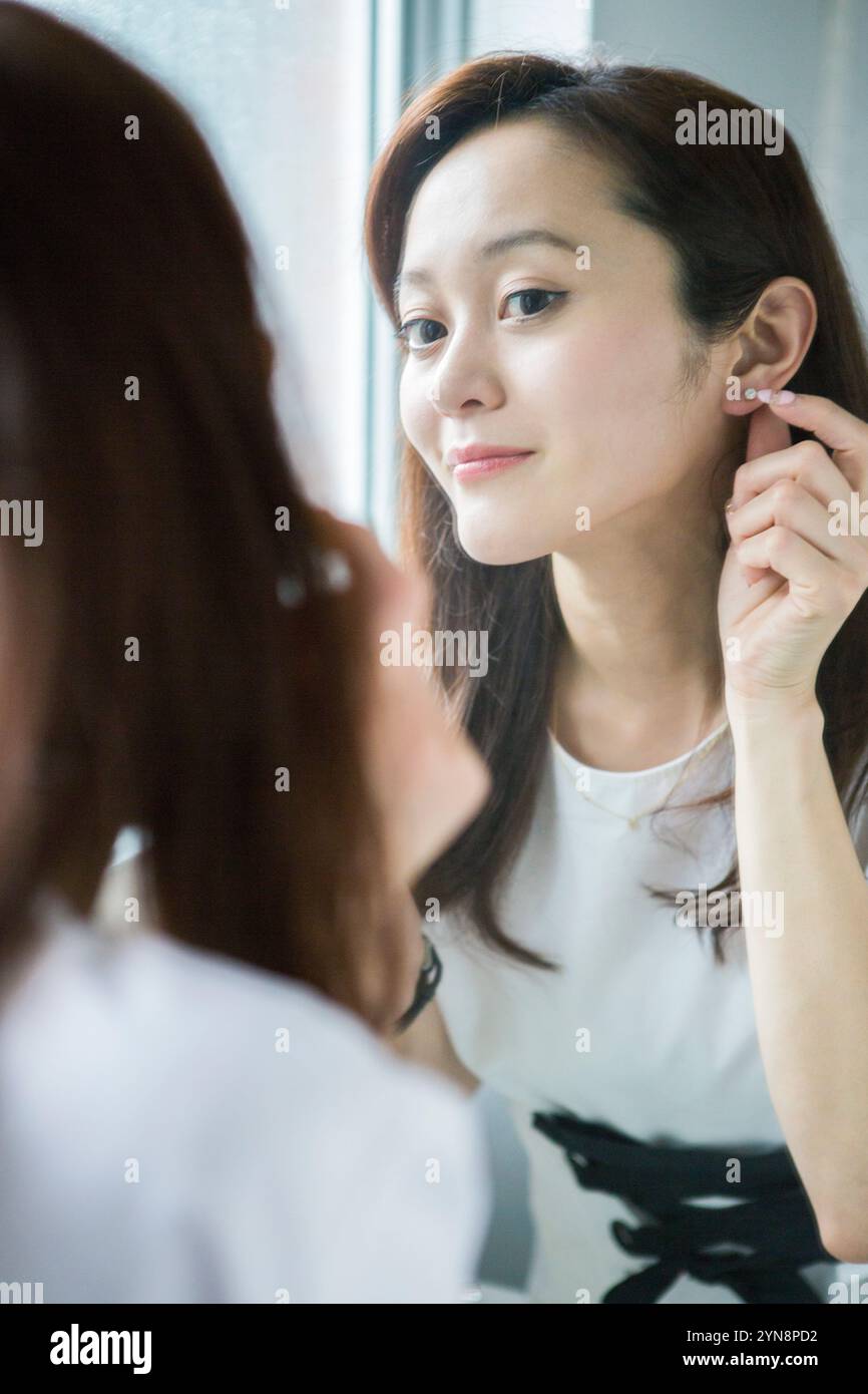 Wearing long earrings hi-res stock photography and images - Alamy