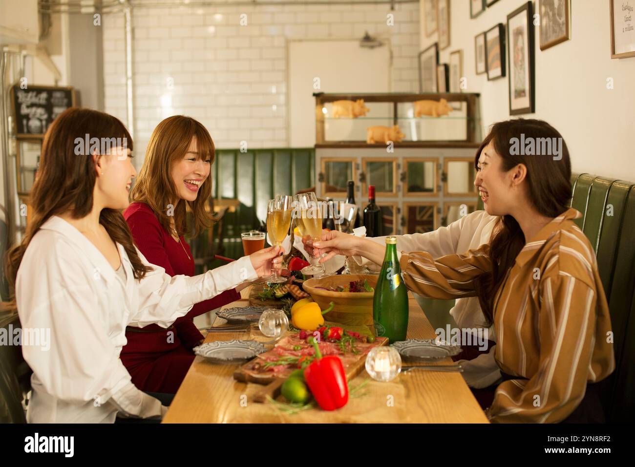 Four women in their 20s enjoying a girls' party Stock Photo - Alamy