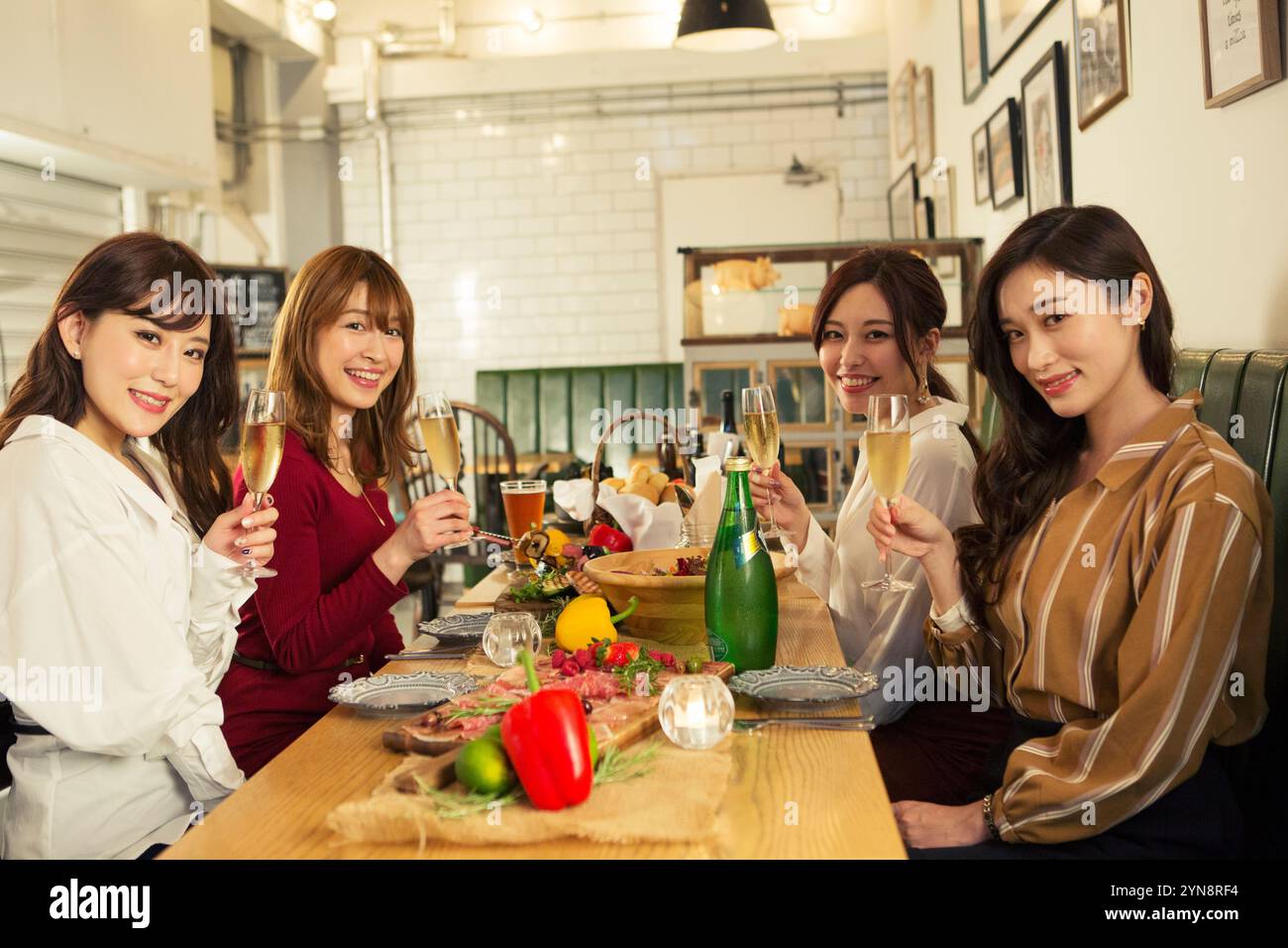 Four women in their 20s enjoying a girls' party Stock Photo - Alamy