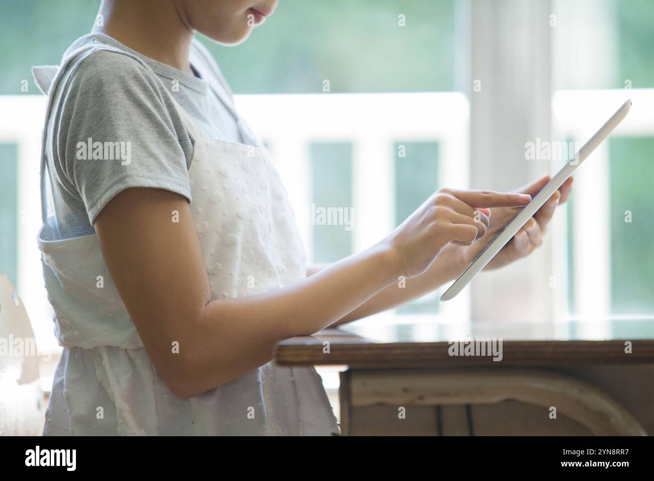 Girls using tablets in the classroom Stock Photo