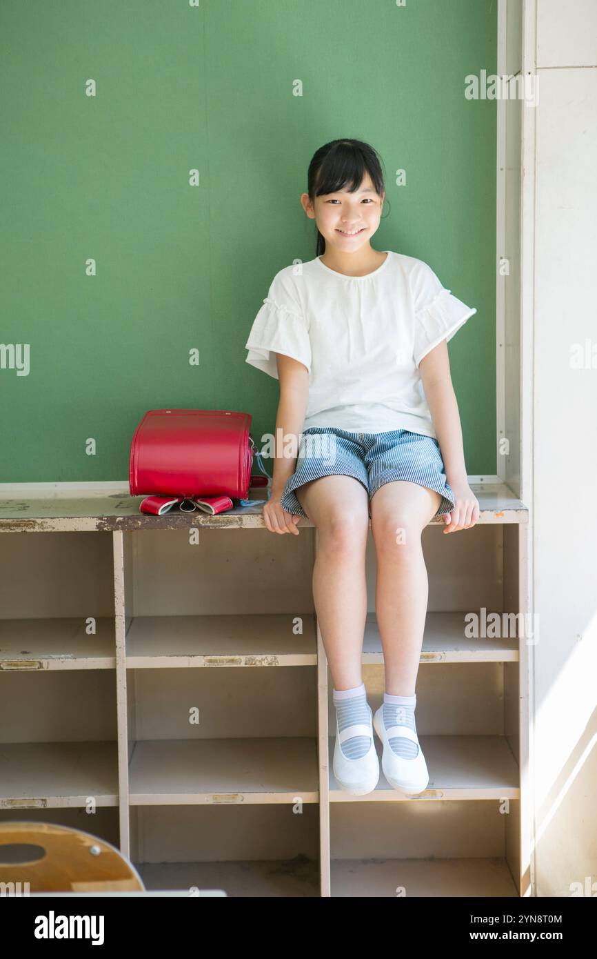 Smiling girl sitting in classroom Stock Photo - Alamy