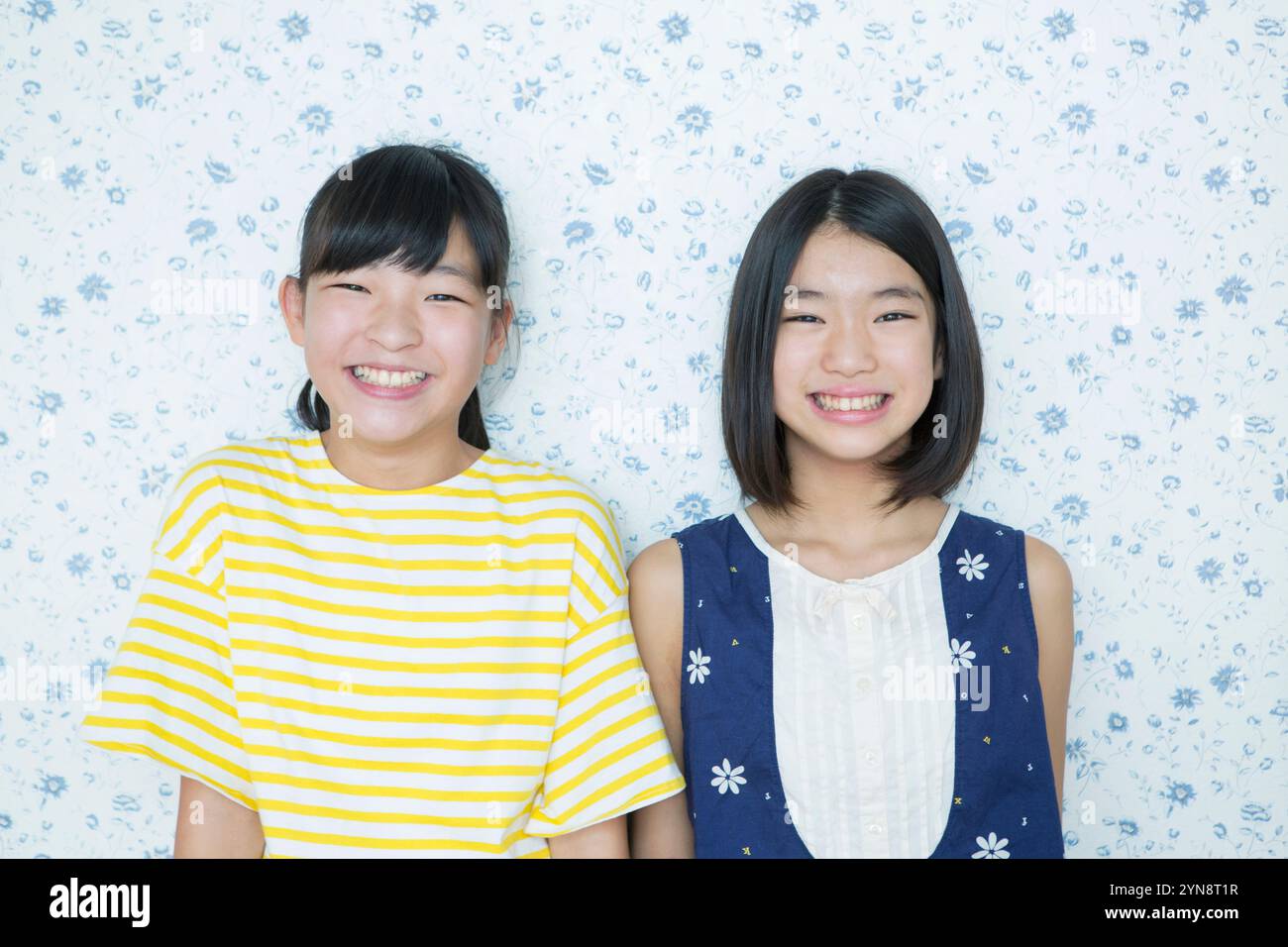 Portrait of two smiling primary school girls Stock Photo - Alamy