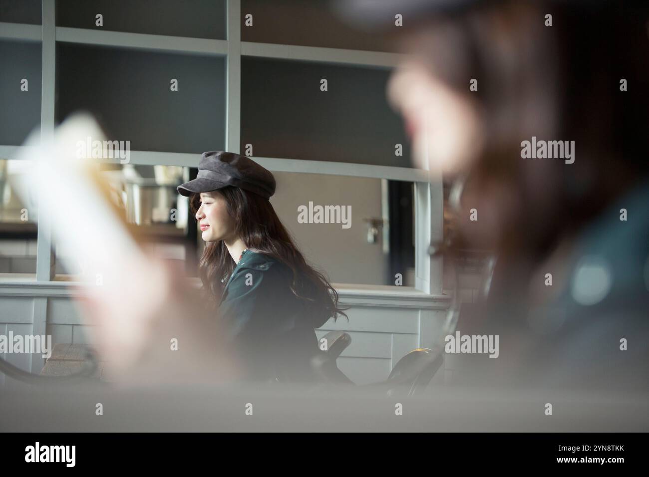 Woman in her 20s through window reading Stock Photo - Alamy