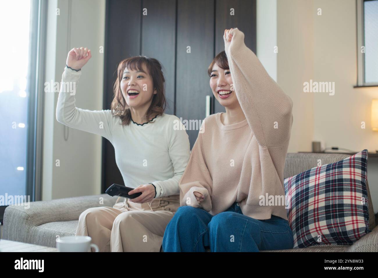 Two women in their 20s enjoying watching sports Stock Photo - Alamy