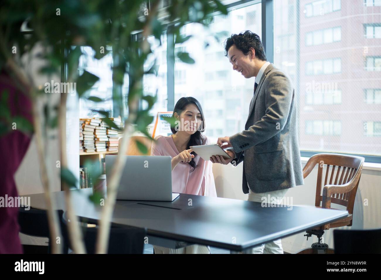 Men and women talking during office work Stock Photo - Alamy