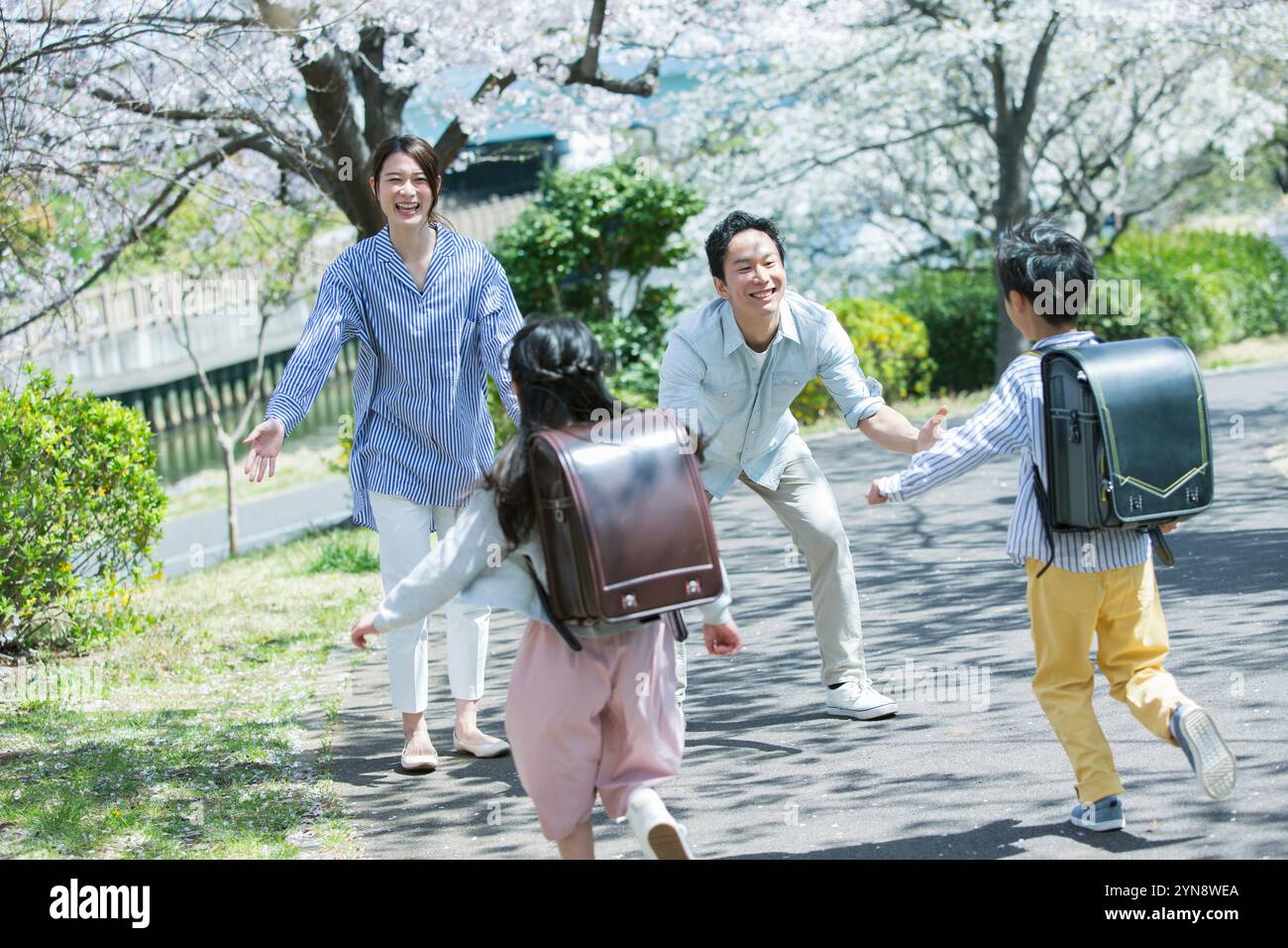 Smiling children running towards their parents at their parents ...