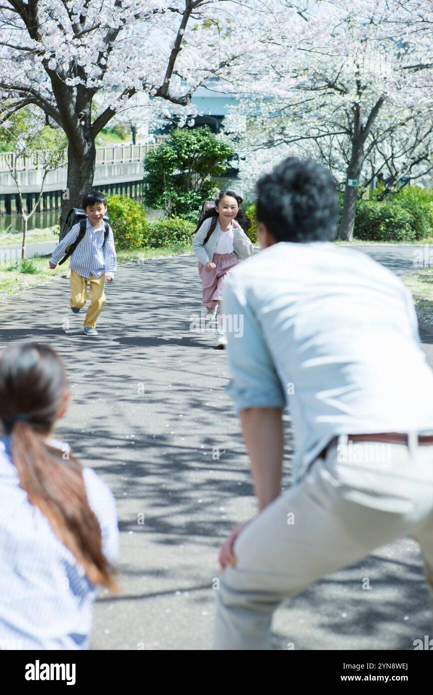 Smiling children running towards their parents at their parents ...