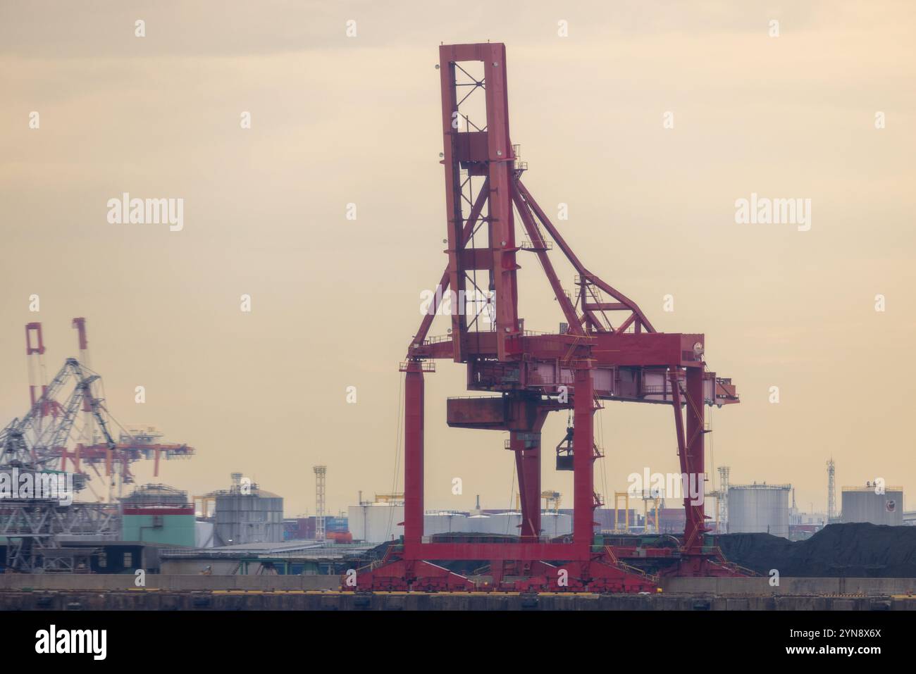 Red Industrial Crane at Coastal Shipping Port Stock Photo