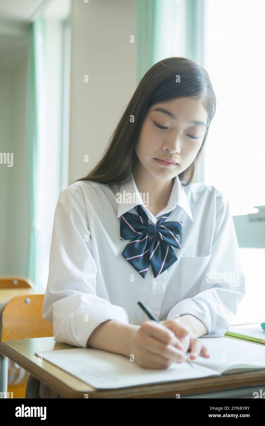 High school girls studying in a classroom Stock Photo - Alamy