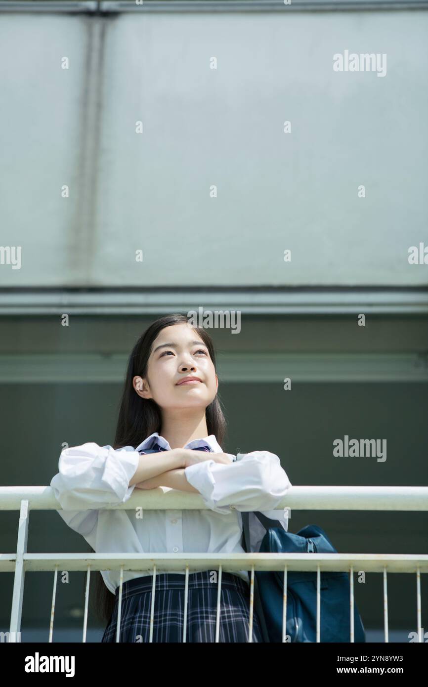 High school girl standing on balcony at school Stock Photo - Alamy